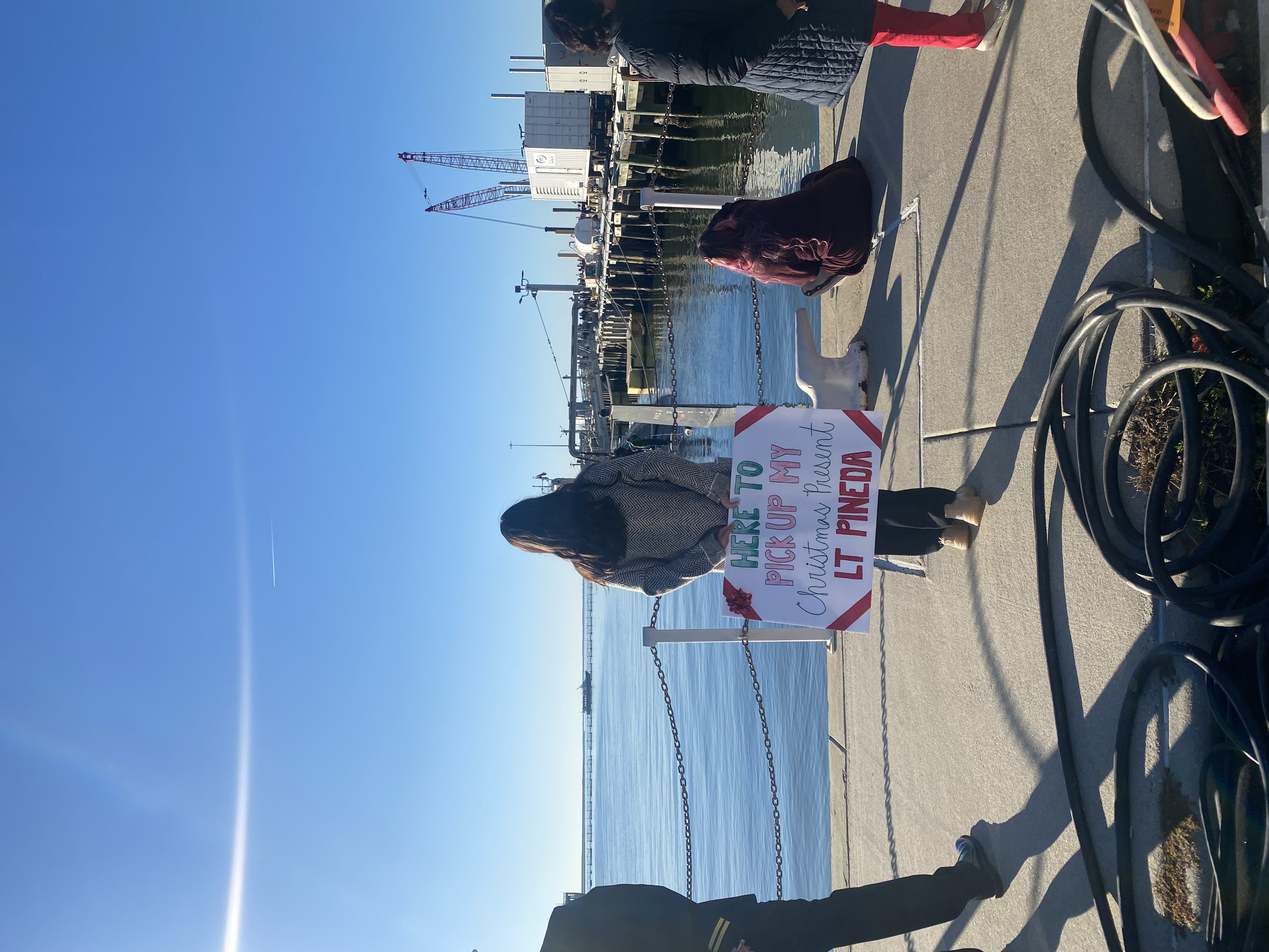 Lauren waiting on the pier in Norfolk for homecoming (December 2023)